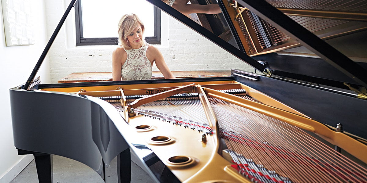 Person Playing Grand Piano