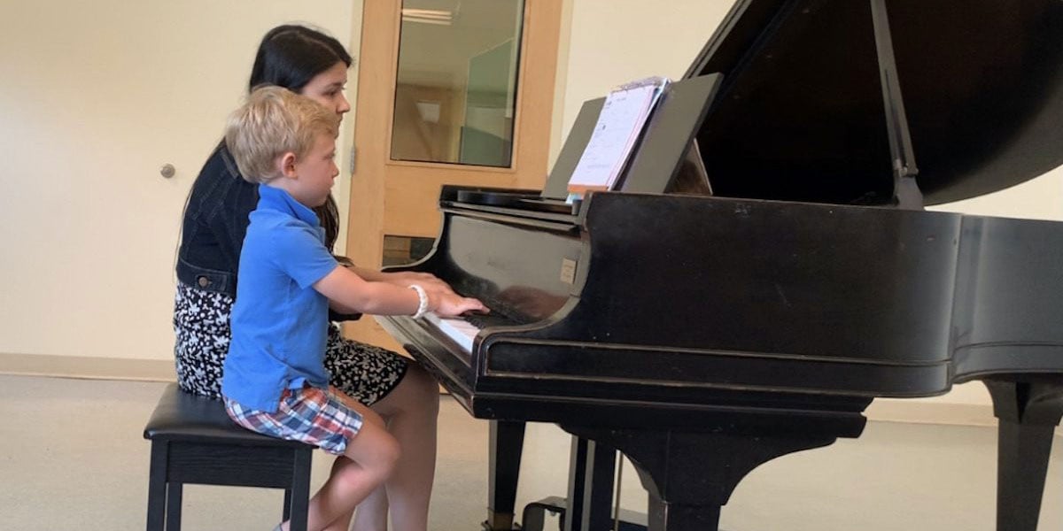 Instructor And Child At Grand Piano