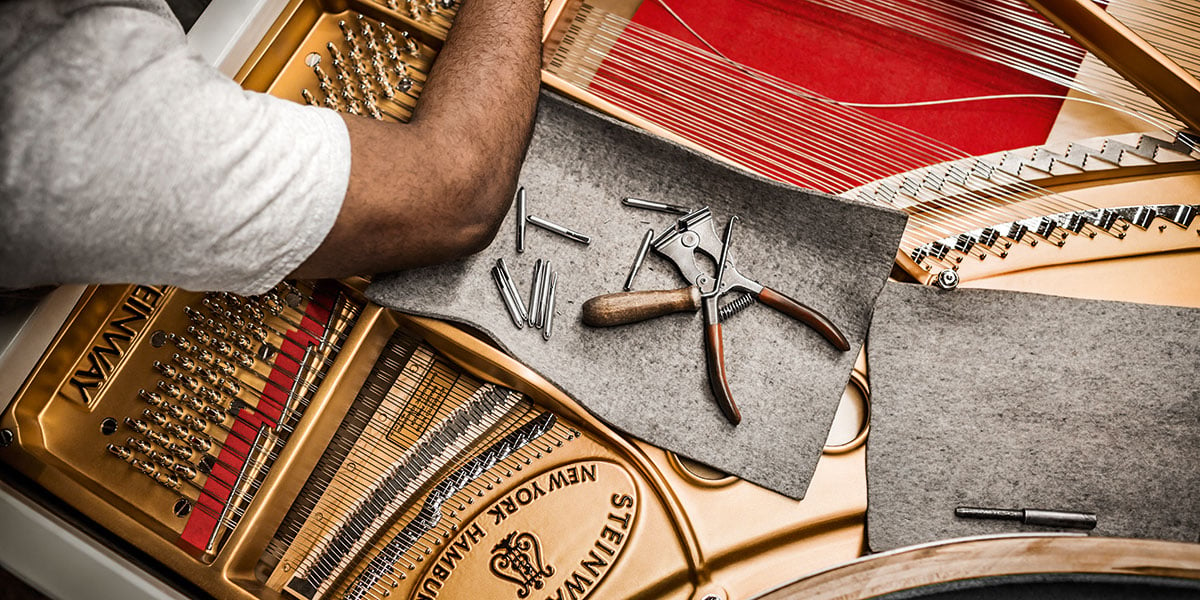 Person Adjusting Piano